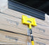 XL corner protector attachment head having just placed a heavy duty plastic corner protector on a pallet of boxes.