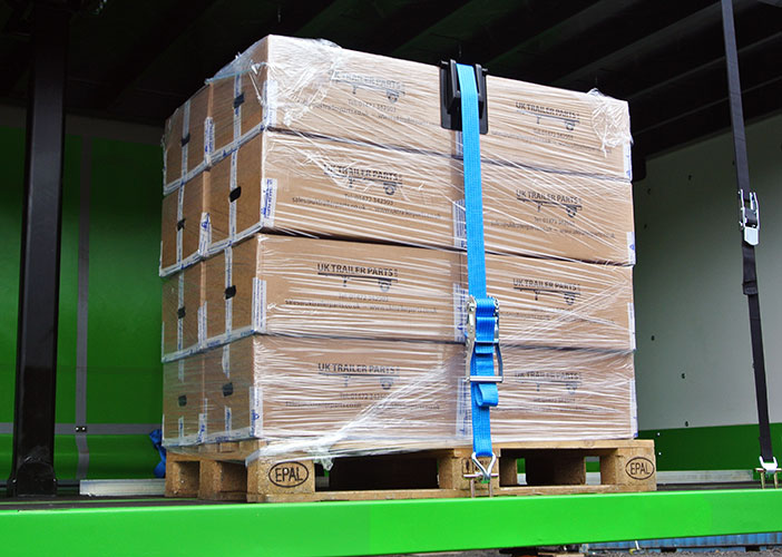 Pallet fitted with a heavy duty plastic corner protector and strap.